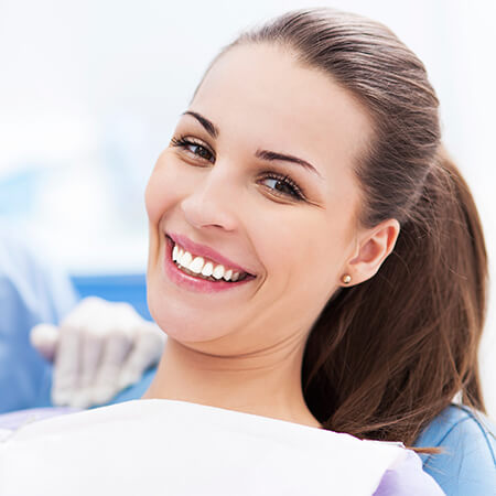 A young woman smiling at the dentist